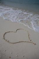 hearts drawn on the sand of a beach photo
