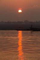 Sunrise on the Ganga river, Varanasi, India photo