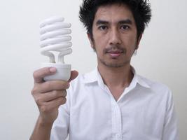 Man holding energy saving bulb for lamp photo