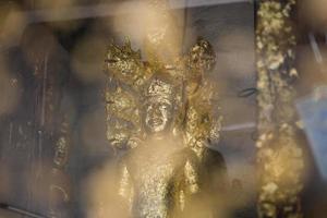 close up Buddha statue gilded in the measure photo