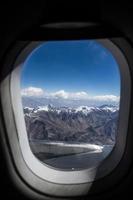 vista aérea del cielo azul con nubes desde la ventana del vuelo en avión foto