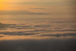 Fog mountain in the early morning sunrise photo