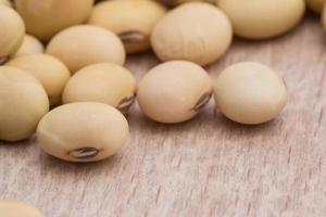 Soy beans on wood background photo