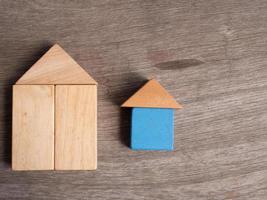 Wooden house toy with wood background photo