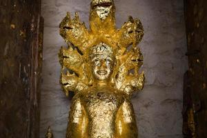 close up Buddha statue gilded in the measure photo