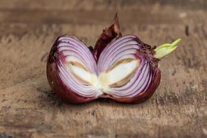 Shallot on brown wooden background photo