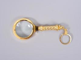 Magnifying glass on grey background photo