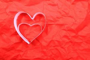 Paper hearts on red background photo