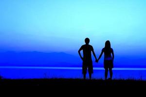 Couple silhouette  at sunset photo