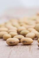 Soy beans on wood background photo