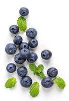 Blueberry fruit top view isolated on a white background, flat lay overhead layout with mint leaf, healthy design concept. photo