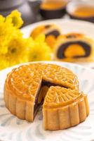 Tasty baked egg yolk pastry moon cake for Mid-Autumn Festival on bright cement table background. Chinese traditional food concept, close up, copy space. photo