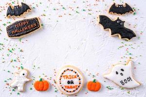 Top view of Halloween festive decorated icing sugar cookies on white background. photo