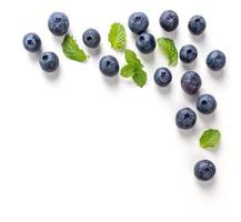 Blueberry fruit top view isolated on a white background, flat lay overhead layout with mint leaf, healthy design concept. photo