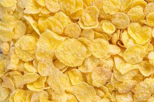 Corn flakes bowl sweets on gray cement background, top view flat lay layout design, fresh and healthy breakfast concept. photo