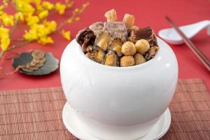 Traditional food of Chinese lunar new year, Buddha jumps over the wall, Chinese Soup Casserole dish, Buddha's Temptation, named Fo Tiao Qiang, close up. photo