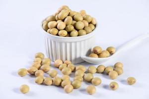 Yellow-green Taiwanese organic non-GMO soybeans, soy beans in a container isolated on white backgorund, close up, clipping path. photo