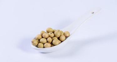 Yellow-green Taiwanese organic non-GMO soybeans, soy beans in a container isolated on white backgorund, close up, clipping path. photo