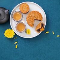 Minimal simplicity layout moon cakes on blue background for Mid-Autumn Festival, creative food design concept, top view, flat lay, copy space. photo