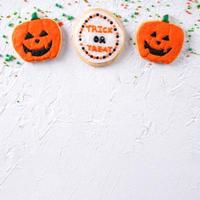 Top view of Halloween festive decorated icing sugar cookies on white background. photo