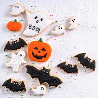 Top view of Halloween festive decorated icing sugar cookies on white background. photo