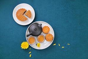 Minimal simplicity layout moon cakes on blue background for Mid-Autumn Festival, creative food design concept, top view, flat lay, copy space. photo