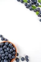 Blueberry fruit top view isolated on a white background, flat lay overhead layout with mint leaf, healthy design concept. photo