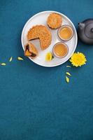 Minimal simplicity layout moon cakes on blue background for Mid-Autumn Festival, creative food design concept, top view, flat lay, copy space. photo