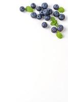 Blueberry fruit top view isolated on a white background, flat lay overhead layout with mint leaf, healthy design concept. photo