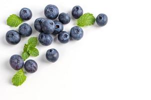Blueberry fruit top view isolated on a white background, flat lay overhead layout with mint leaf, healthy design concept. photo