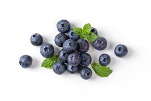 Blueberry fruit top view isolated on a white background, flat lay overhead layout with mint leaf, healthy design concept. photo