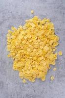 Corn flakes bowl sweets on gray cement background, top view flat lay layout design, fresh and healthy breakfast concept. photo