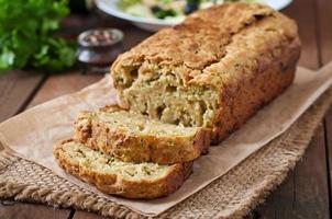 Zucchini bread with cheese on a wooden background photo