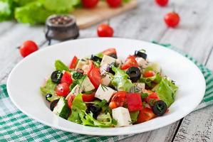 Greek salad  with fresh vegetables, feta cheese and black olives photo