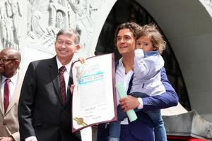 LOS ANGELES, APR 2 - Leron Gubler, Orlando Bloom, Flynn Bloom at the Orlando Bloom Hollywood Walk of Fame Star Ceremony at TCL Chinese Theater on April 2, 2014 in Los Angeles, CA photo