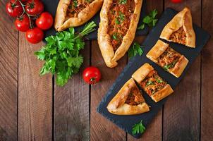 Turkish pide traditional food with beef and vegetables photo