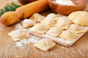 Freshly made homemade delicious homemade ravioli with a roller photo