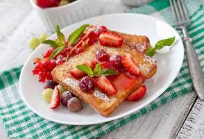 French toast with berries and jam for breakfast photo