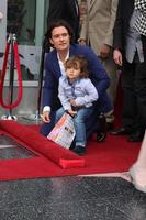 LOS ANGELES, APR 2 - Orlando Bloom, Flynn Bloom at the Orlando Bloom Hollywood Walk of Fame Star Ceremony at TCL Chinese Theater on April 2, 2014 in Los Angeles, CA photo