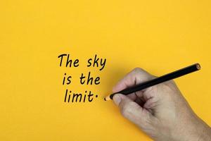 THE SKY IS THE LIMIT text written on a yellow background. Business concept. photo