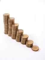 Savings, increasing columns of gold coins isolated on white background photo