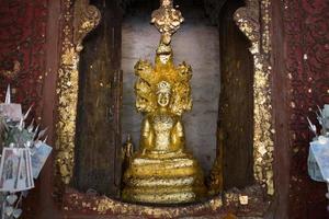 close up Buddha statue gilded in the measure photo