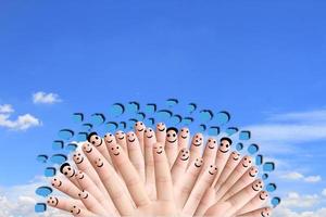 group of finger faces with social chat sign and speech bubbles photo