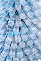 rows of empty plastic bottles at bottling plant photo