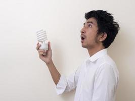 Man holding energy saving bulb for lamp photo