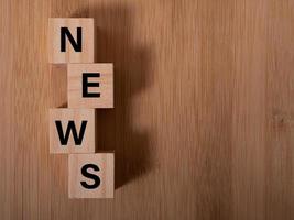 Wooden news sign on a table in an office photo