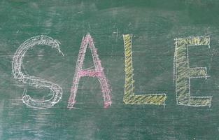 Sale written on blackboard photo