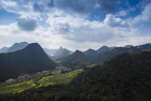 Spring fresh landscape of colorful fields, sunrise sky and beautiful hills valley photo