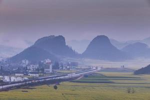 Yellow rapeseed flower field with the mist in Luoping, China photo