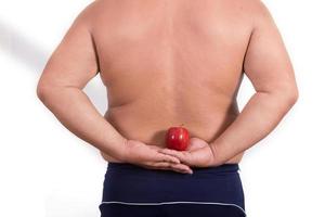 hombre gordo con una manzana en la mano foto